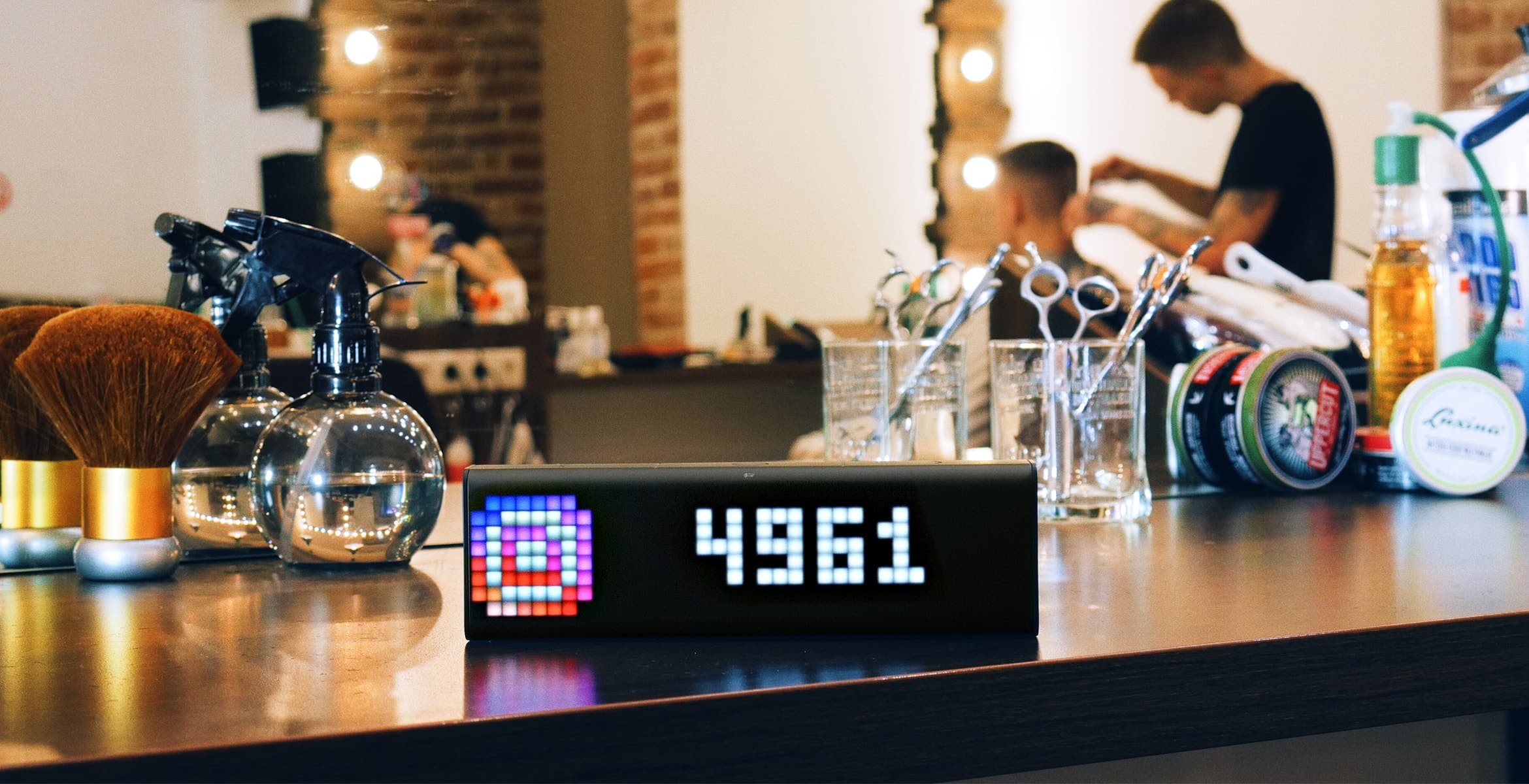 LaMetric Time smart clock, placed at the barbershop, displays follower count for your Instagram account
