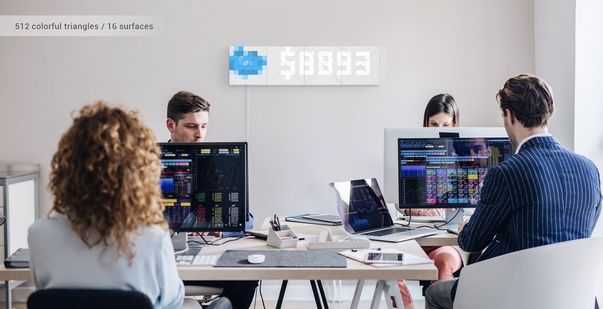 Infoscreen, assembled from 16 smart light surfaces, displays revenue from the SalesForce, in front of the office workers