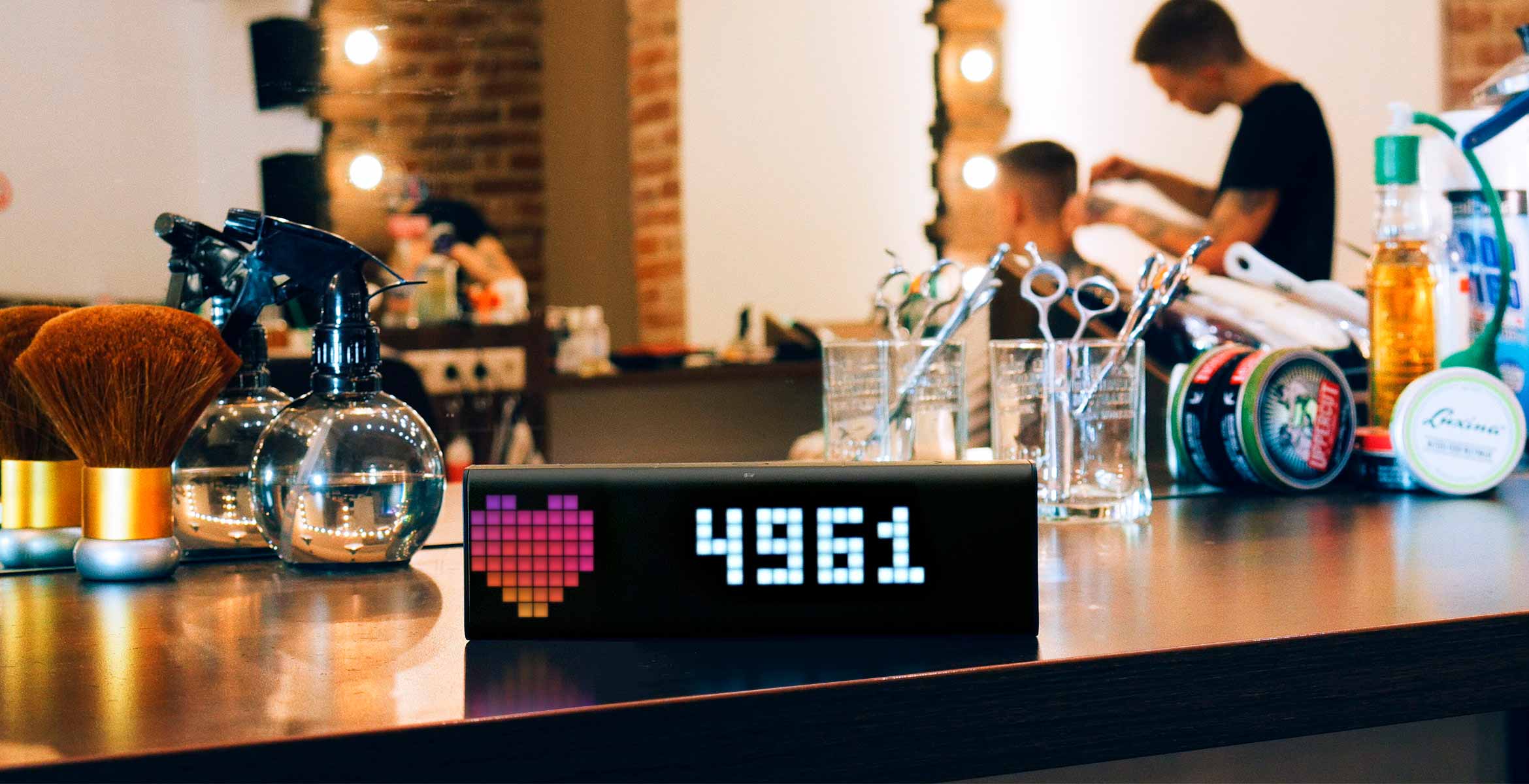 LaMetric Time smart clock, placed at the barbershop, displays follower count for your Instagram account
