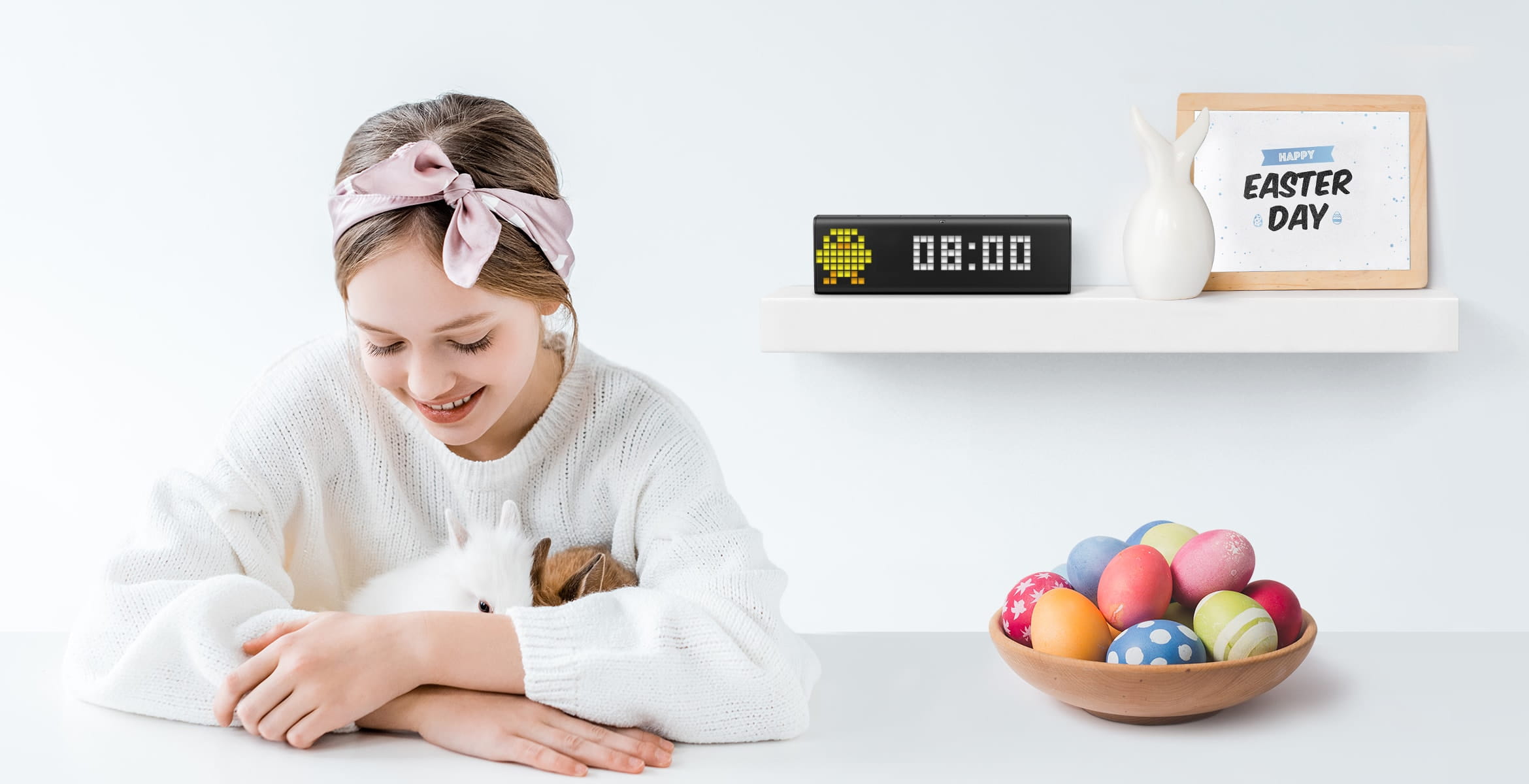 LaMetric Time smart clock shows time and a festive clock face, standing in a room with Easter Day decorations