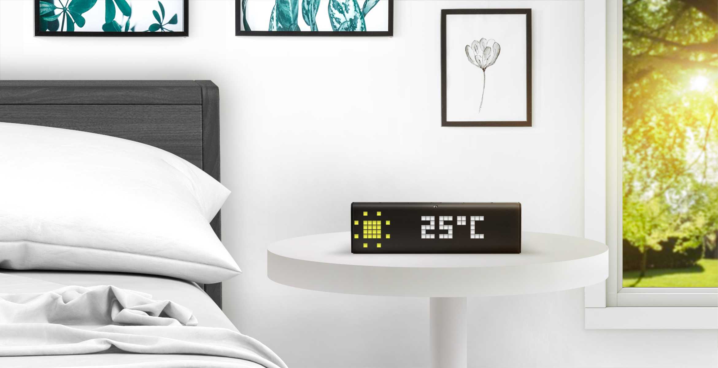 LaMetric Time digital clock displays weather, standing on the table near the bed