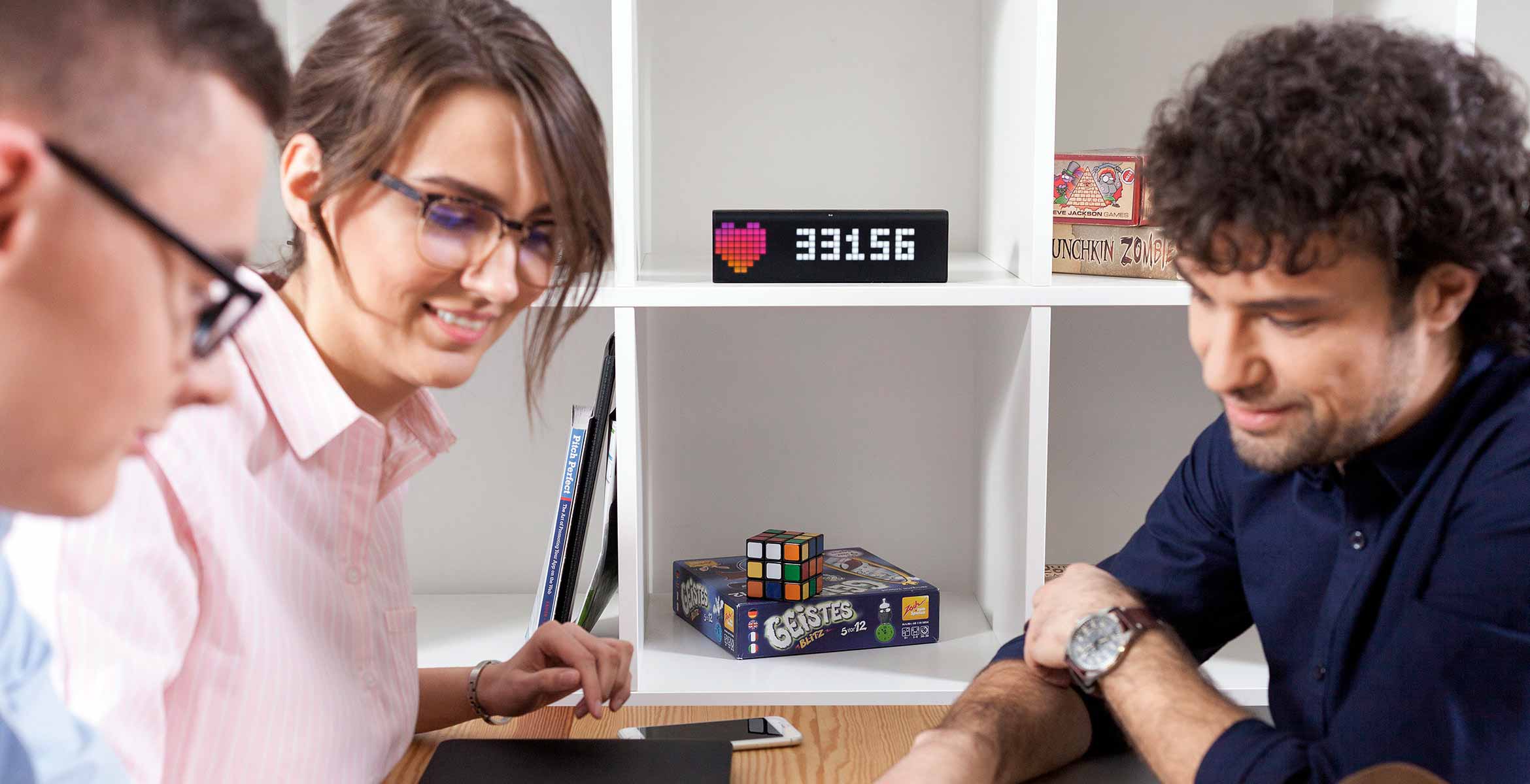 LaMetric Time smart clock, placed in a shelf, displays people follower count for the Instagram