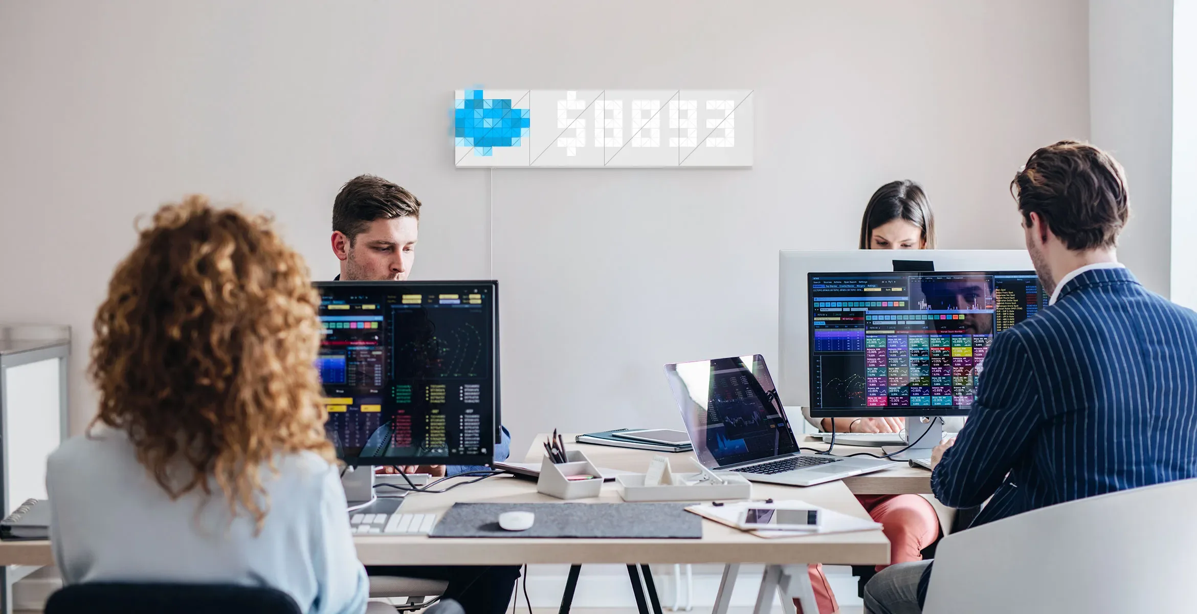 Infoscreen, assembled from 16 smart light surfaces, displays revenue from the SalesForce, in front of the office workers