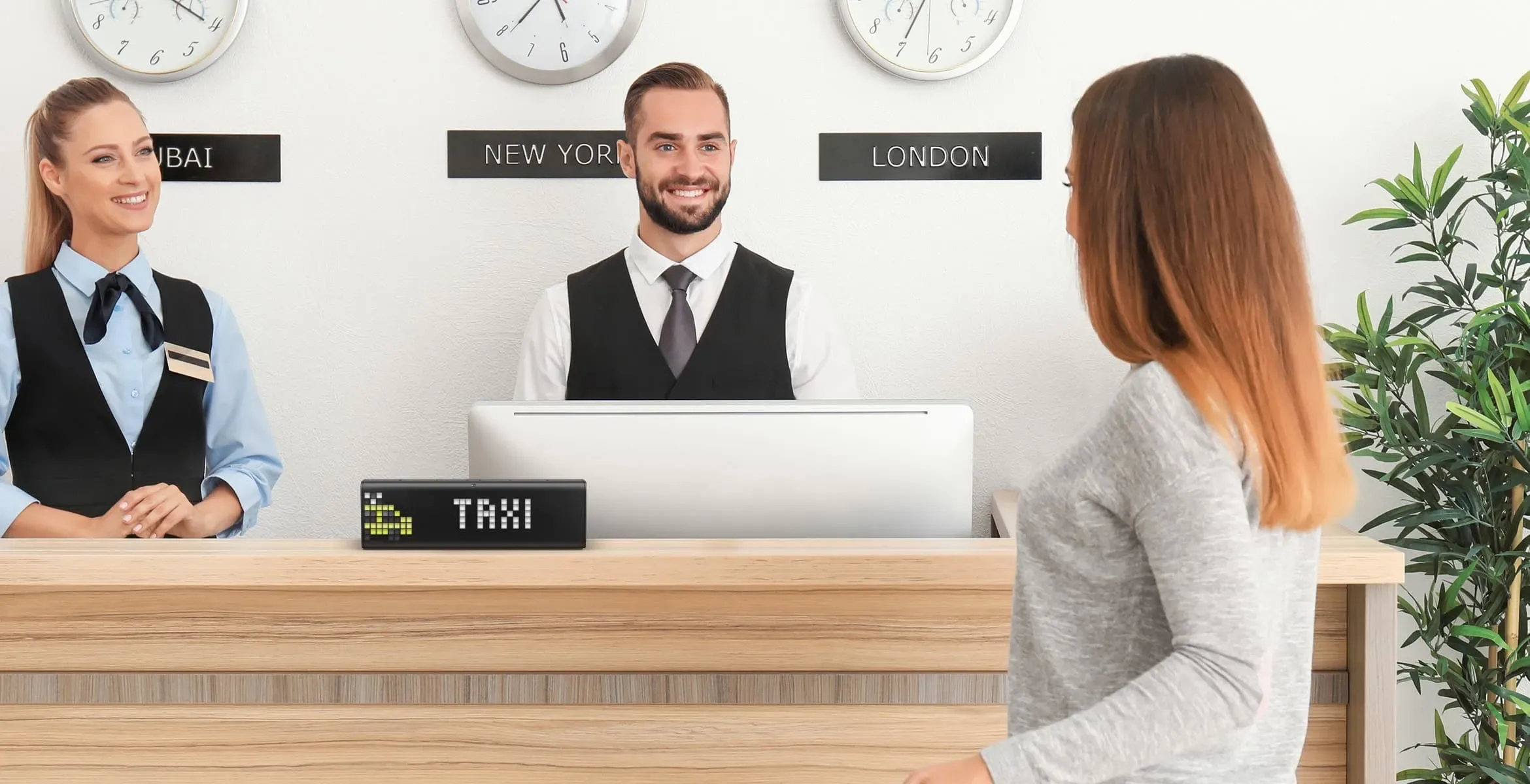 A smart clock, placed on the counter in a hotel, displays integration with IFTTT, which allows ordering taxi using one button