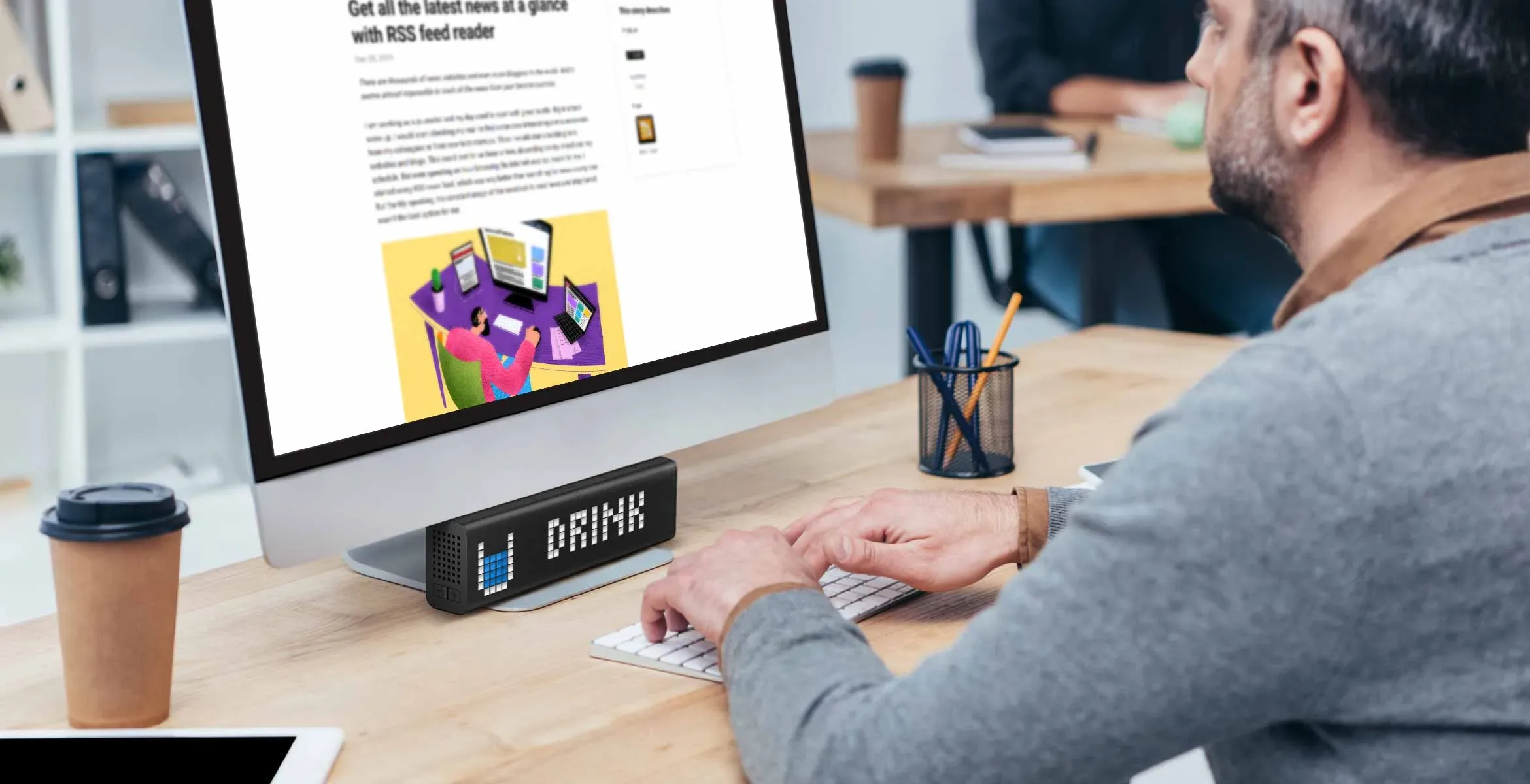 LaMetric Time smart clock complements the desk setup and displays a reminder to "Drink" water