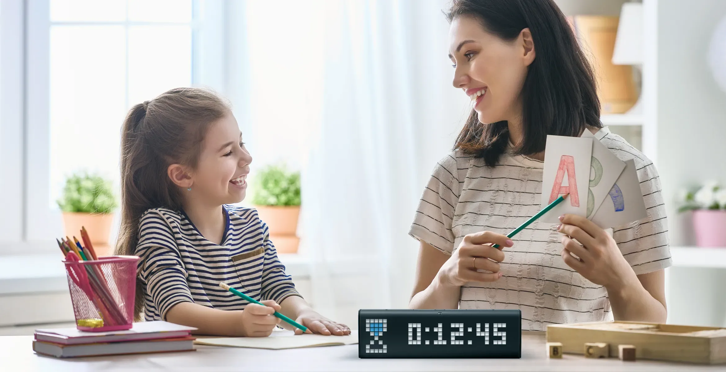 LaMetric Time digital clock stands on the table and shows the time countdown